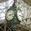 Close-up of post clock face with "F1" hands and "FS" at Milwaukee Airport
